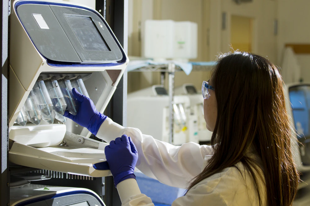 Researcher preparing samples in a bioinformatics laboratory