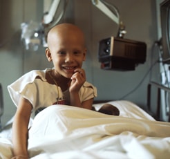 child sitting on bed