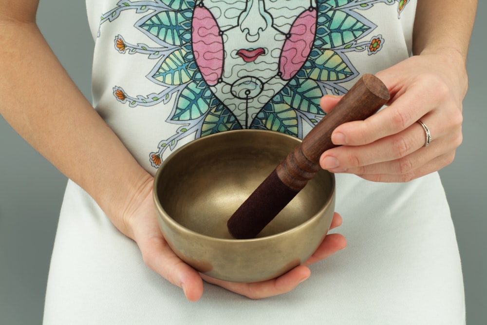 person holding singing bowl