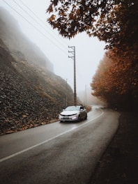 Car winding along the Atlas Mountains during autumn.