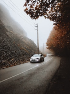 Car winding along the Atlas Mountains during autumn.