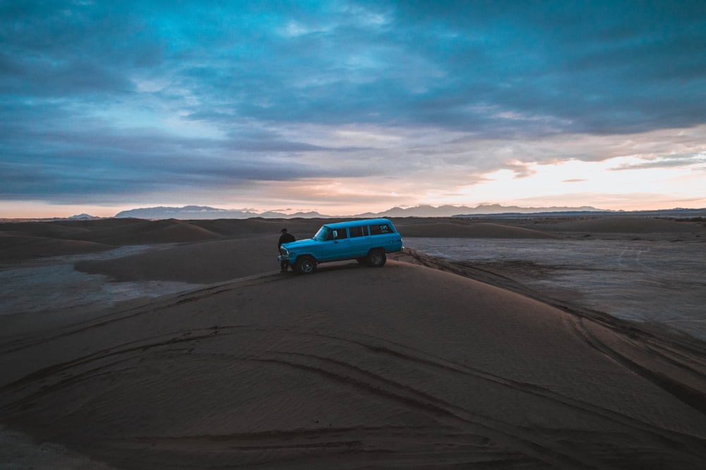 blue SUV on sand