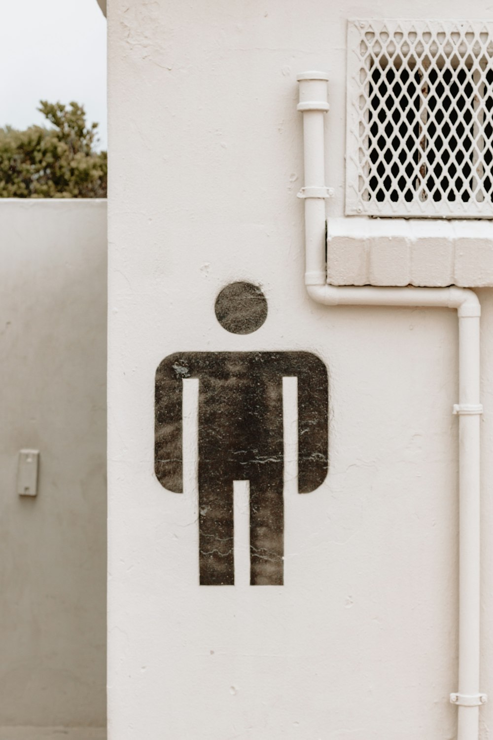 a toilet sign on the side of a building