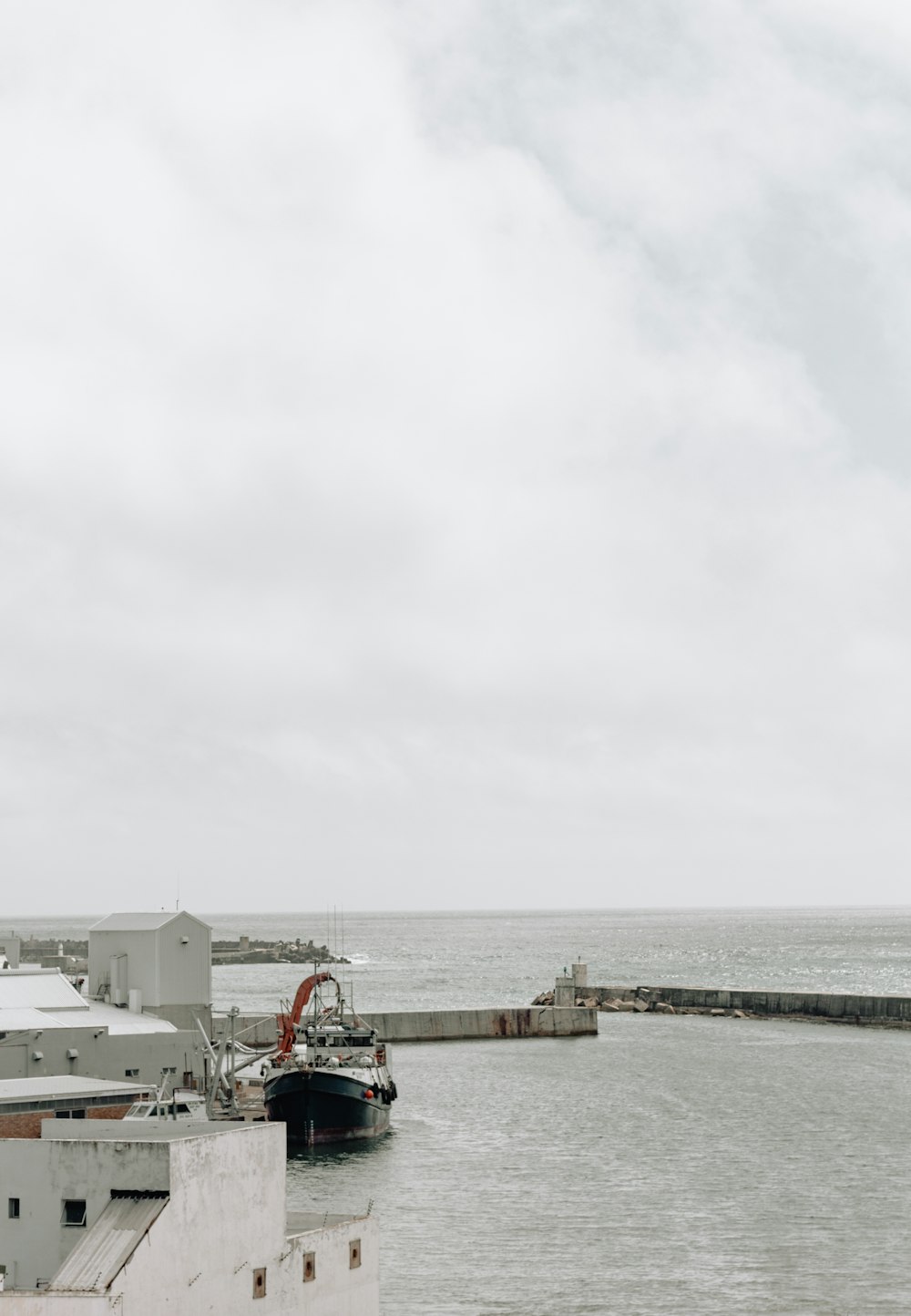 black boat beside dock during daytime