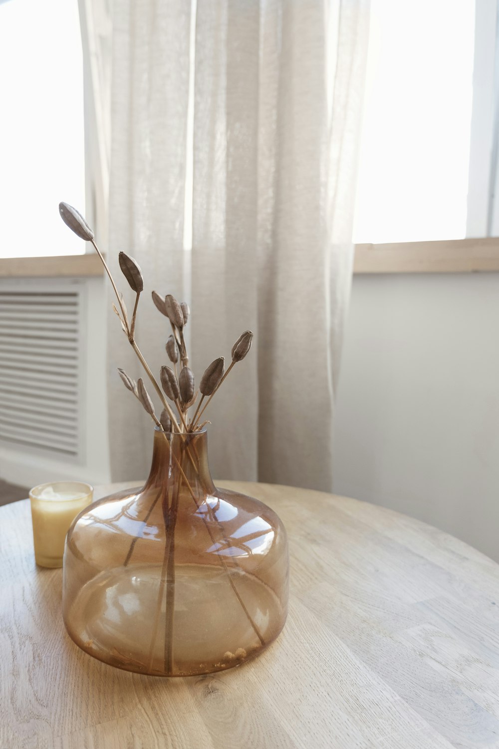 a table with a vase and candle on it