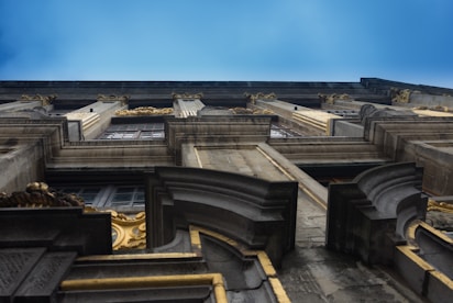 A luxurious gold-accented facade detail shining against a dark blue sky.