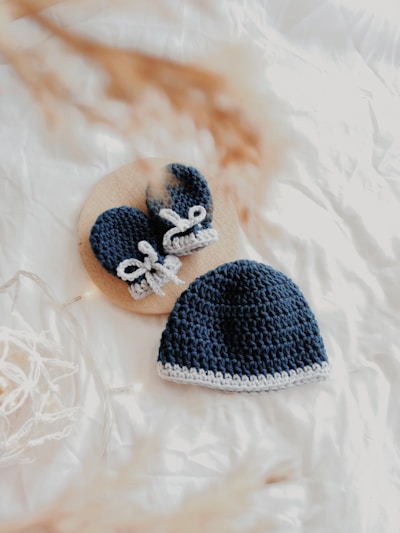 babys black knit cap and gloves