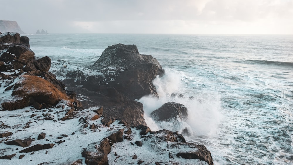 black stone in sea during daytime