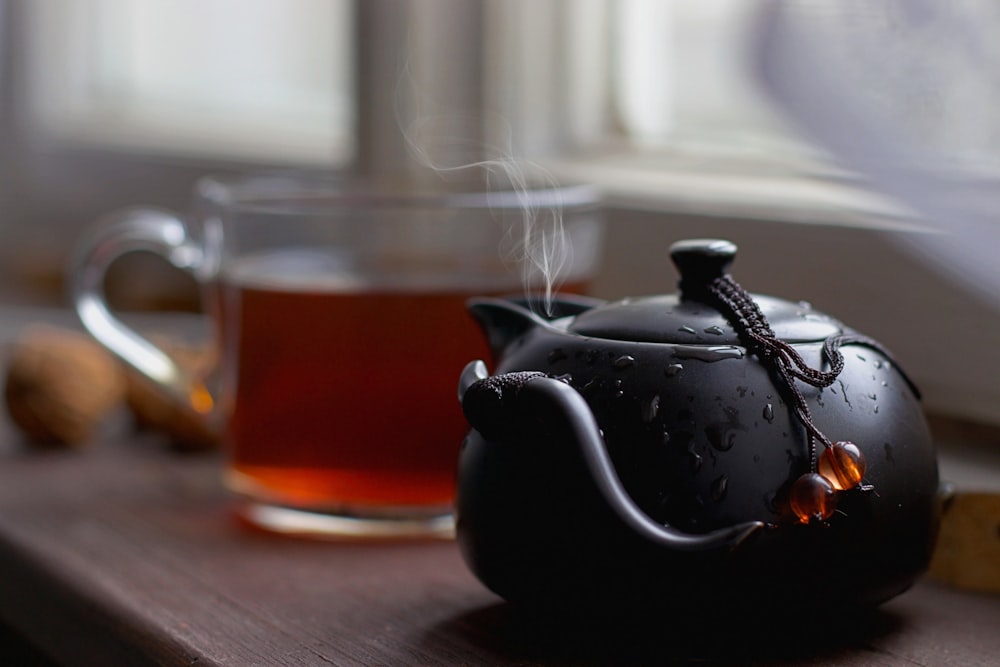 black teapot near clear glass mug