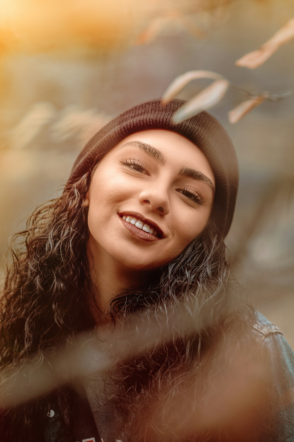 smiling woman wearing black knit cap