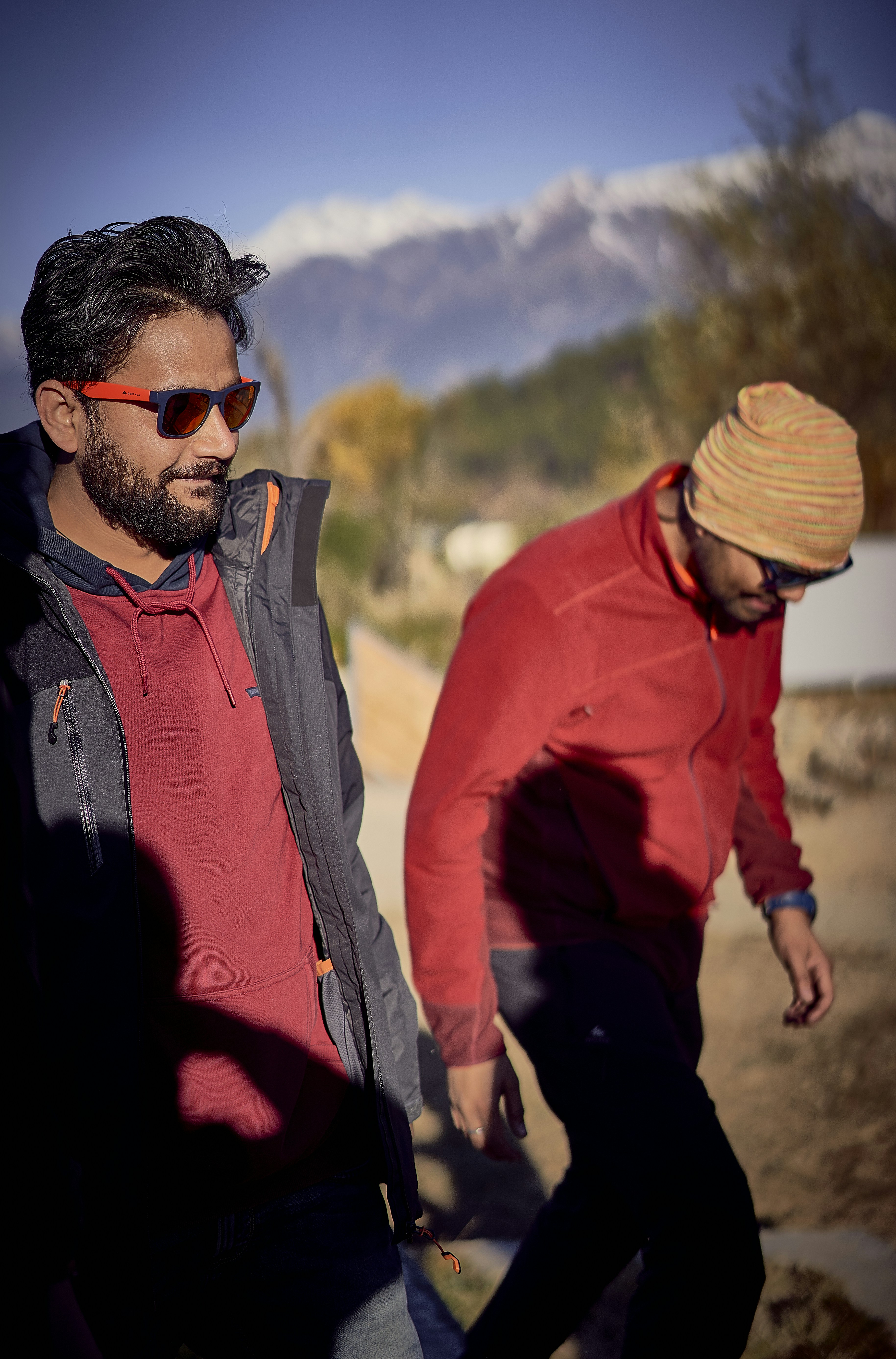 two man walking on mountain during daytime