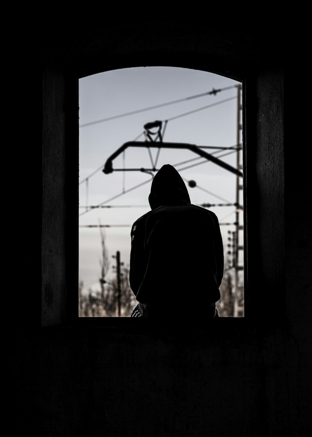 silhouette of person wearing hoodie
