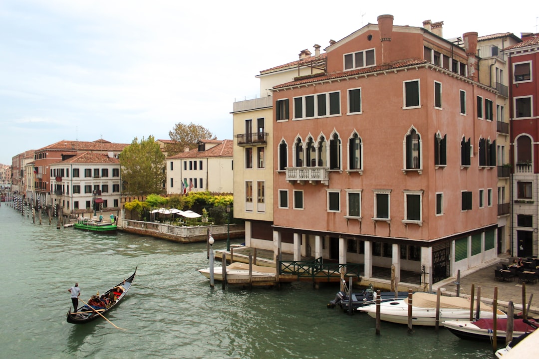 canoe on calm body of water in front of building