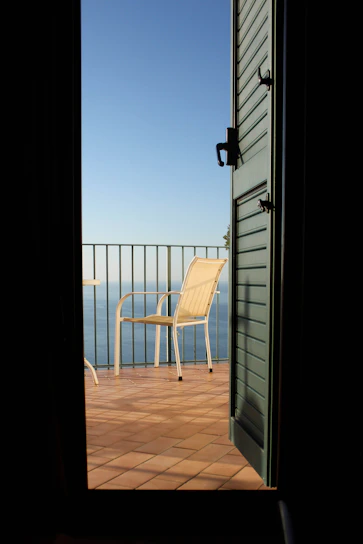 Balcony view overlooking the calm sea and city skyline.