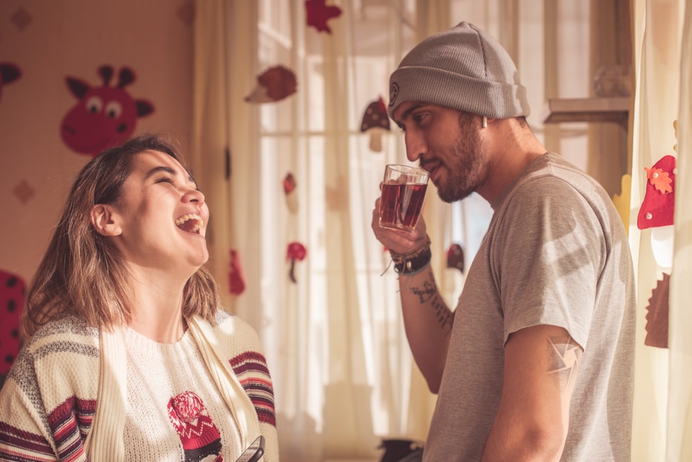 smiling woman in front of man