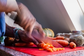 Students chopping fresh vegetables swiftly during a knife skills session