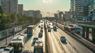 a highway filled with lots of traffic next to tall buildings