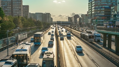 a highway filled with lots of traffic next to tall buildings