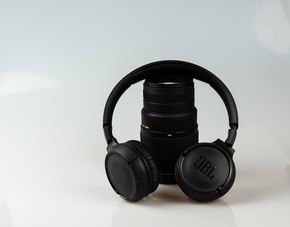 black JBL cordless headphones on black zoom lens