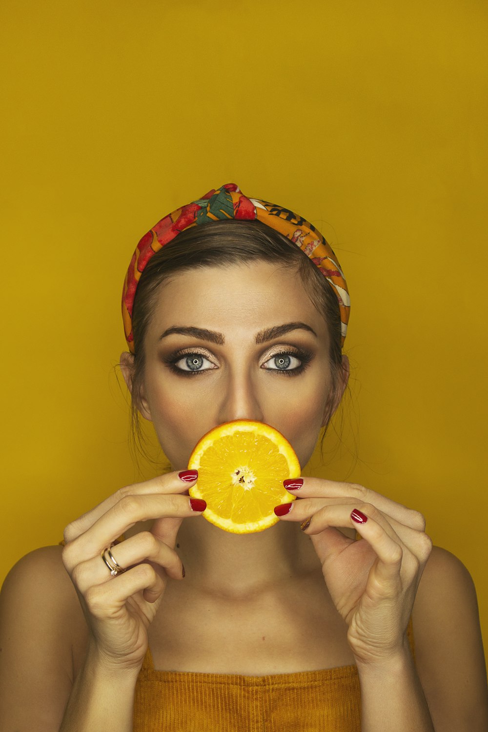 woman holding sliced citrus