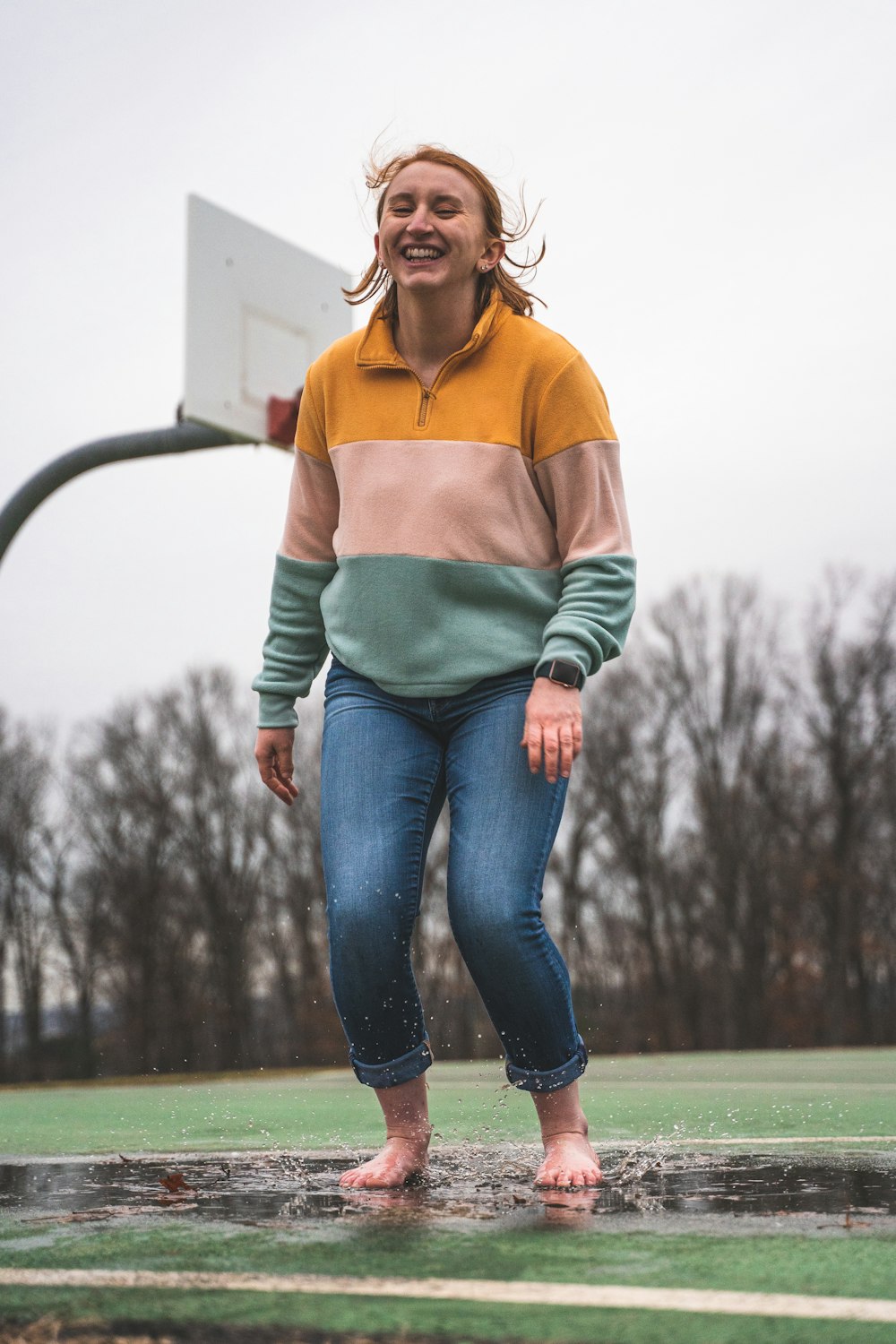 woman stepping on pavement with water