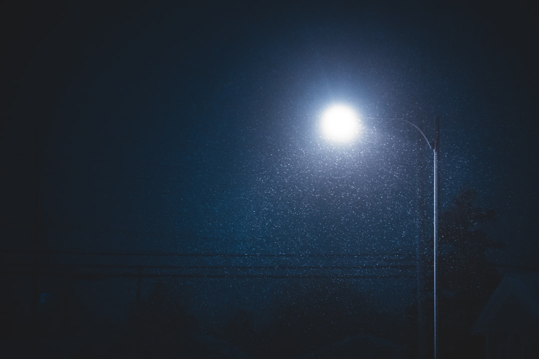 gray lighted post light during night