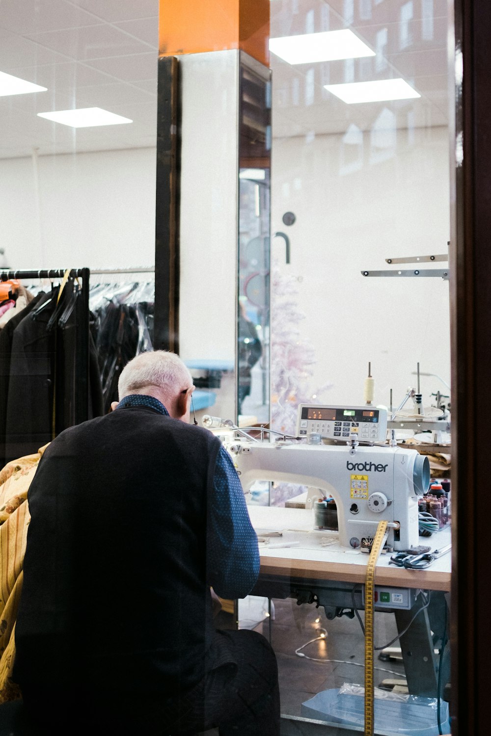 sitting man sewing