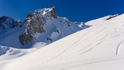 A pristine snow-dusted landscape showcasing a potential ski lodge site with Mt Rainier in the background.