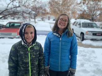 Happy customers standing outside their clear driveway after service.