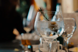 Close-up of a crystal-clear gin and tonic with a fresh lime wedge and delicate bubbles rising