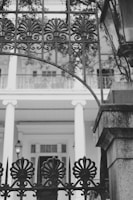 Modern aluminum gate with clean lines framing a beautiful French garden entrance.