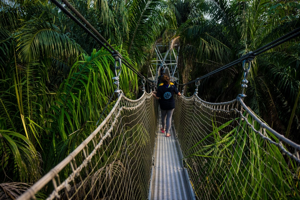 unknown person walking on hanging bridge