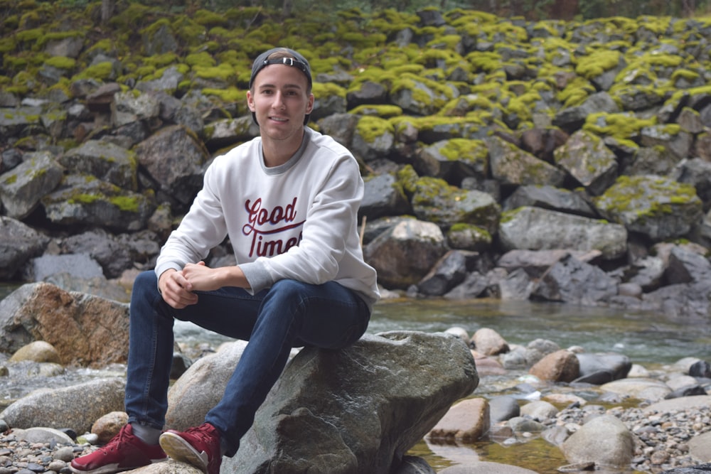 man sitting on rock formation