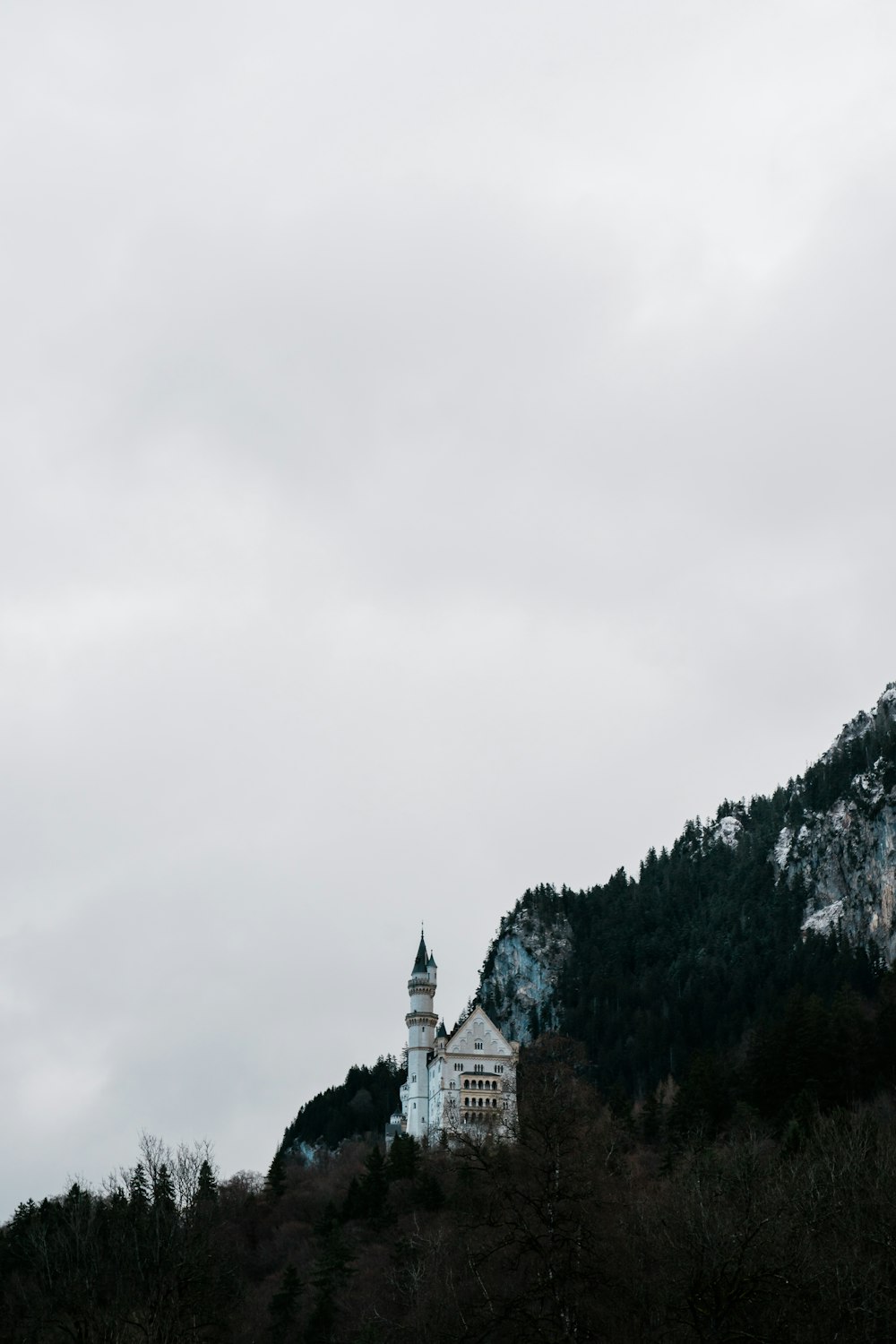 a church on a hill with a mountain in the background