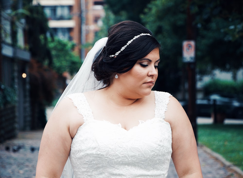 shallow focus photo of woman in white thick strap top