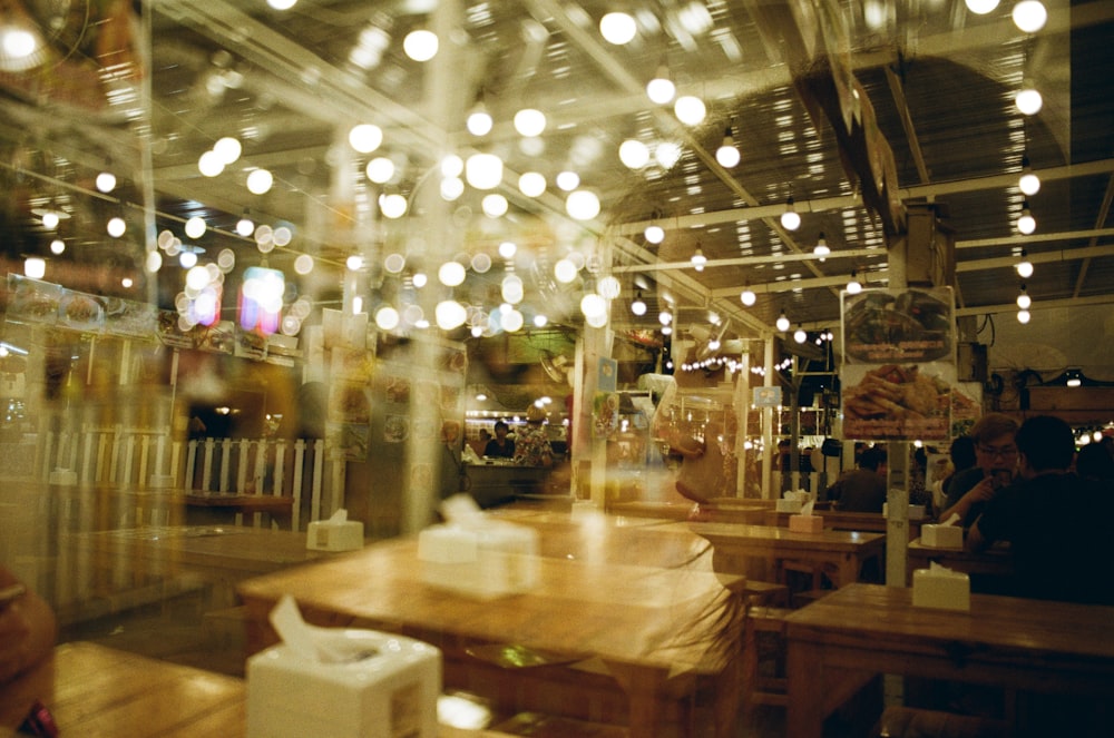 people gathering on restaurant with lights