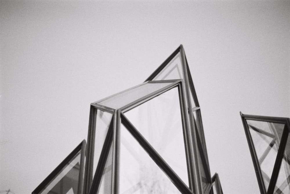low-angle grayscale photography of glass building