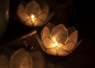 three lighted yellow tealights