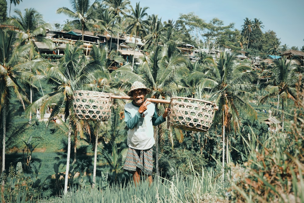 man carrying baskets