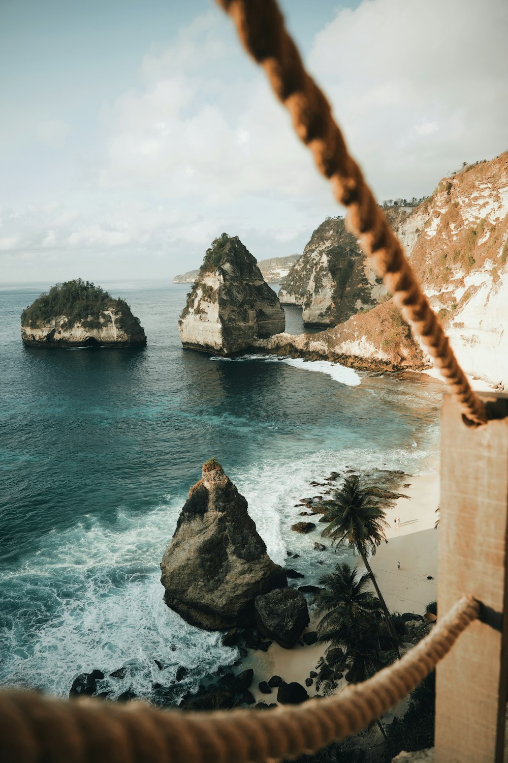 wide-angle photography of mountain cliff beside seashore during daytime