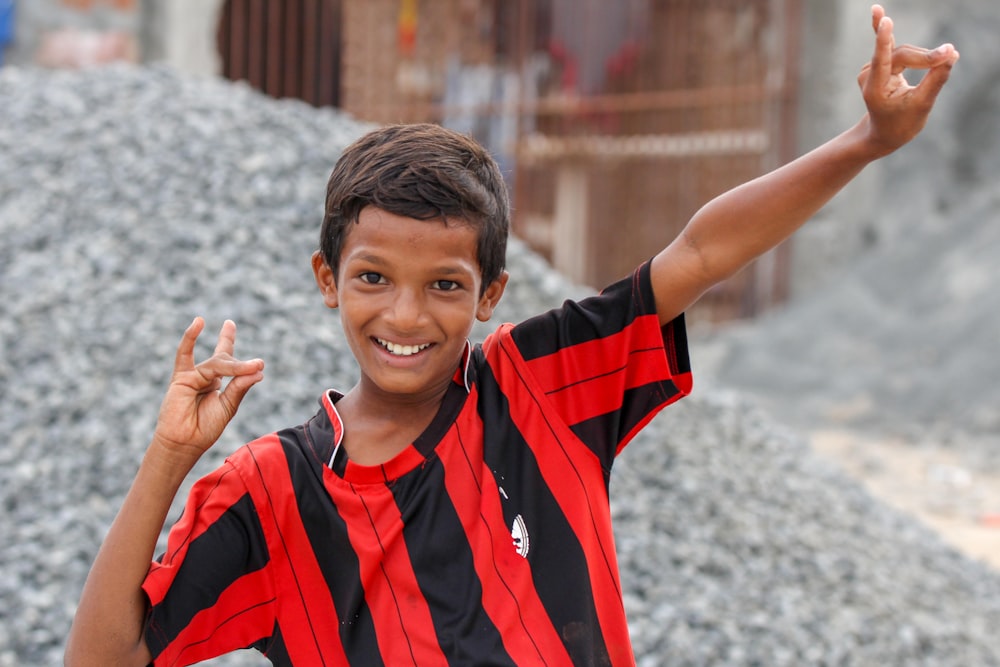 boy wearing red and black stripe crew-neck t-shirt