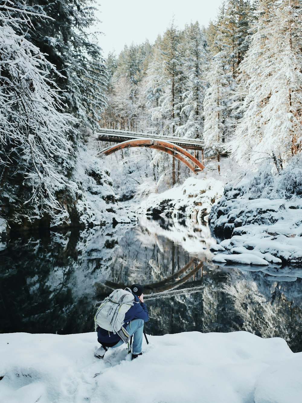 a person with a backpack standing in the snow