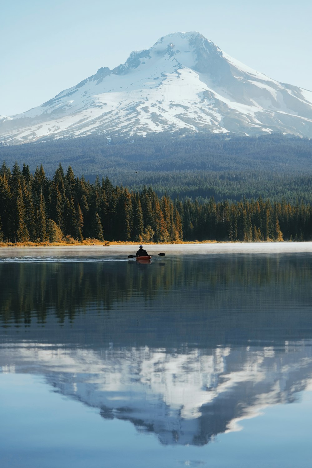 reflection of mountain alps on body of water during daytime