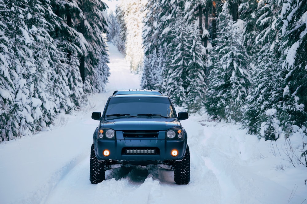 black SUV on snow-covered road