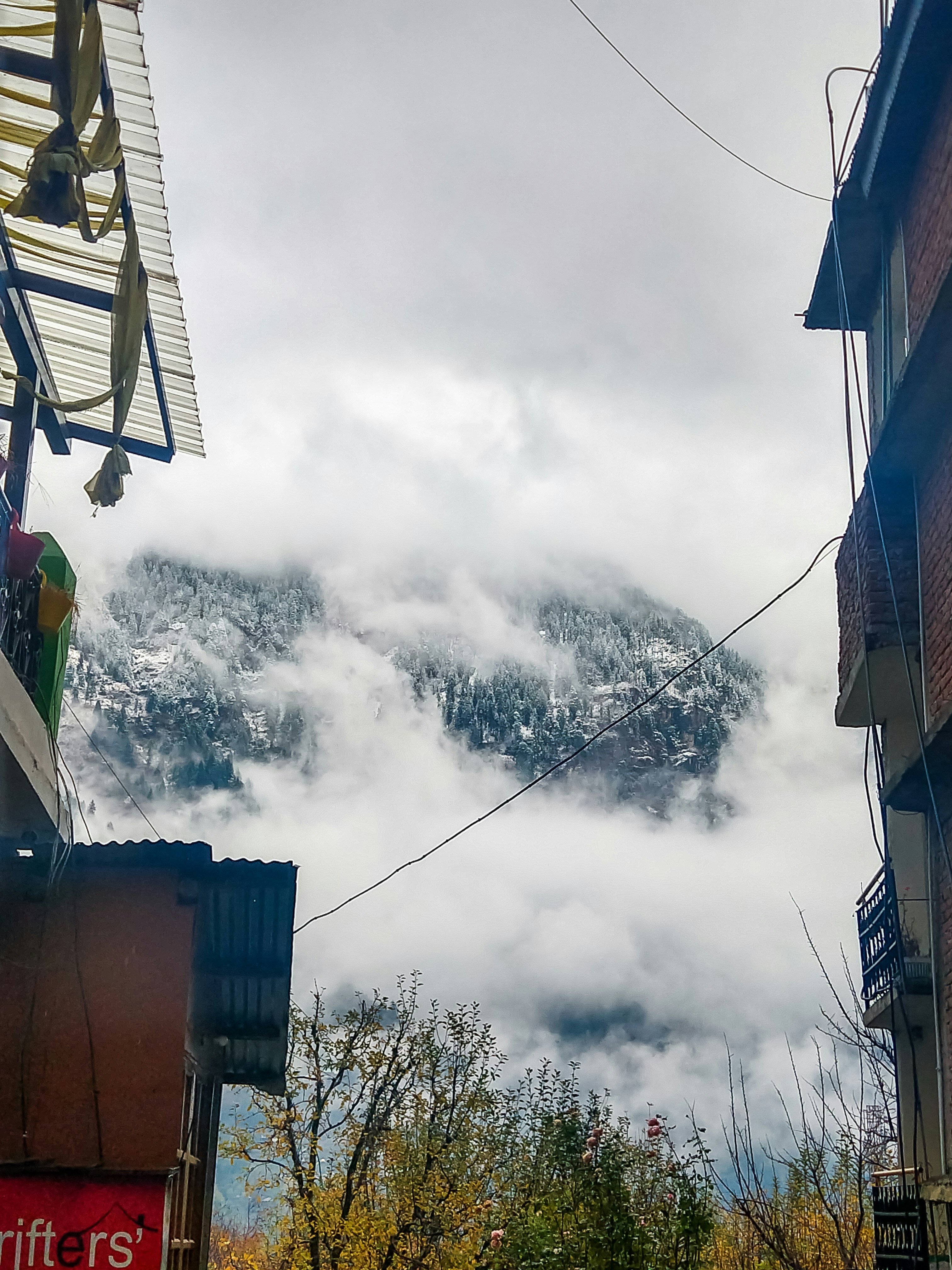 a view of a mountain covered in clouds