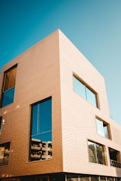 A modern architectural building with large glass windows.