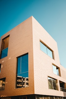 A modern architectural building with large glass windows.