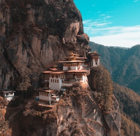 a cliff side with a building on top of it