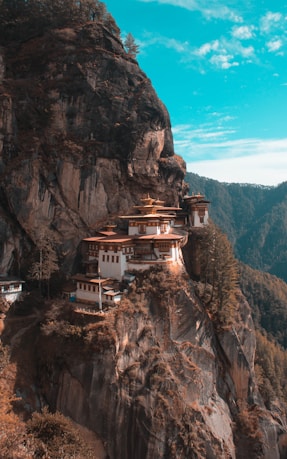 a cliff side with a building on top of it