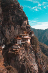 a cliff side with a building on top of it